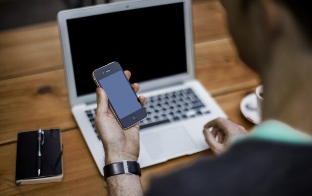 Man with smartphone, laptop - Wikimedia