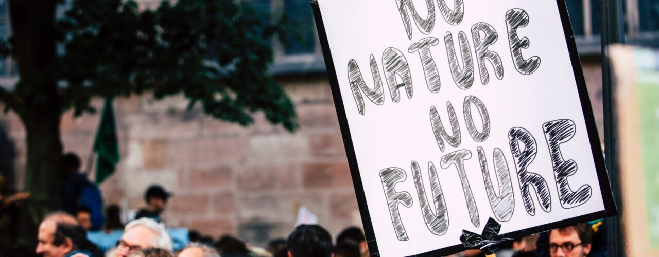 man holding No Mature No Future signage