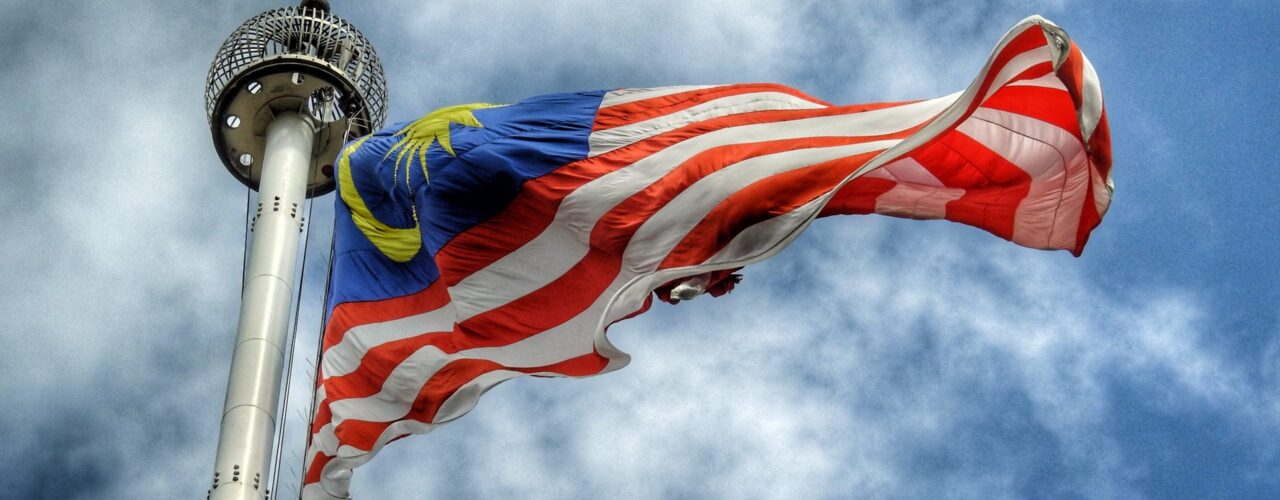 low angle photography of waving flag of Malaysia during daytime
