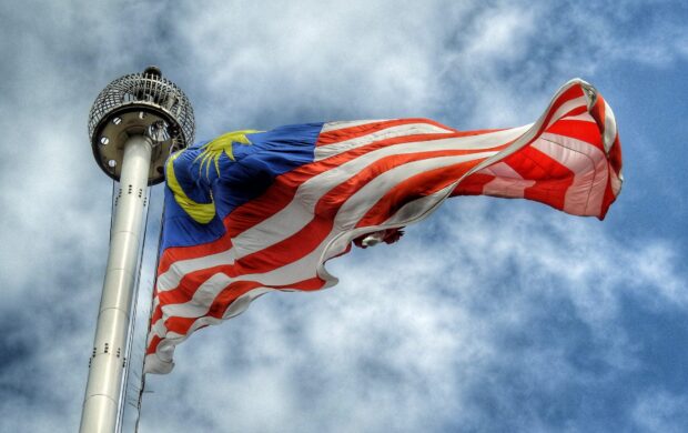 low angle photography of waving flag of Malaysia during daytime