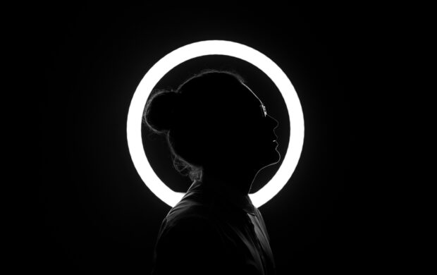woman standing beside halo light