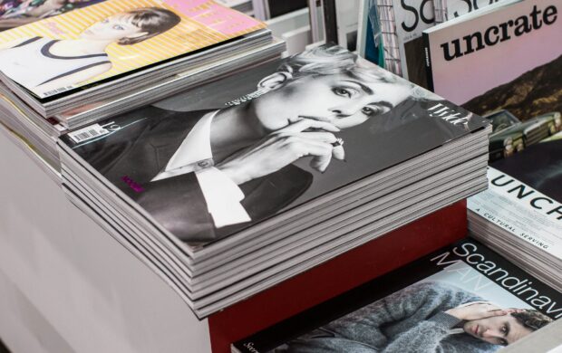 stack of assorted-title book lot arranged on white wooden table