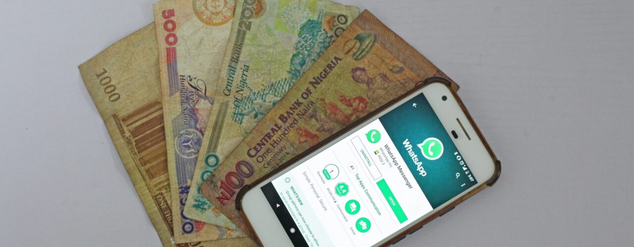 white Android smartphone beside banknotes