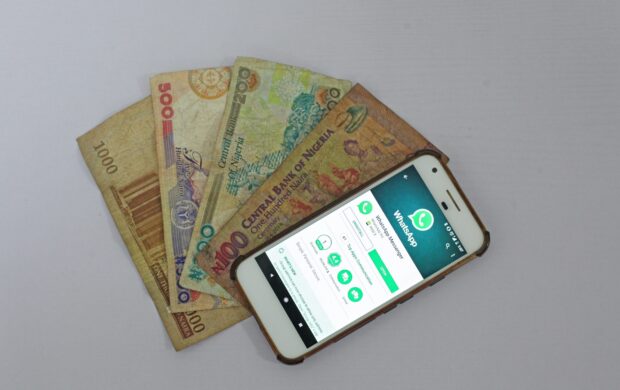 white Android smartphone beside banknotes