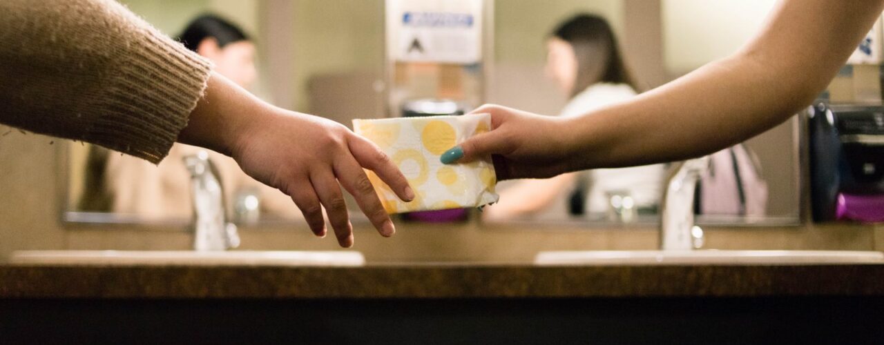 person holding white and blue ceramic mug