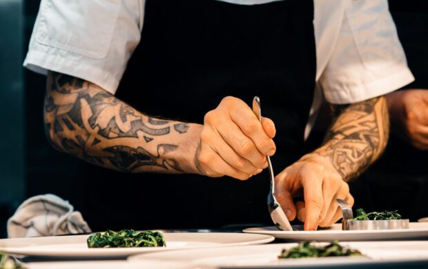 person putting food on plate - food industry's leaders of the future