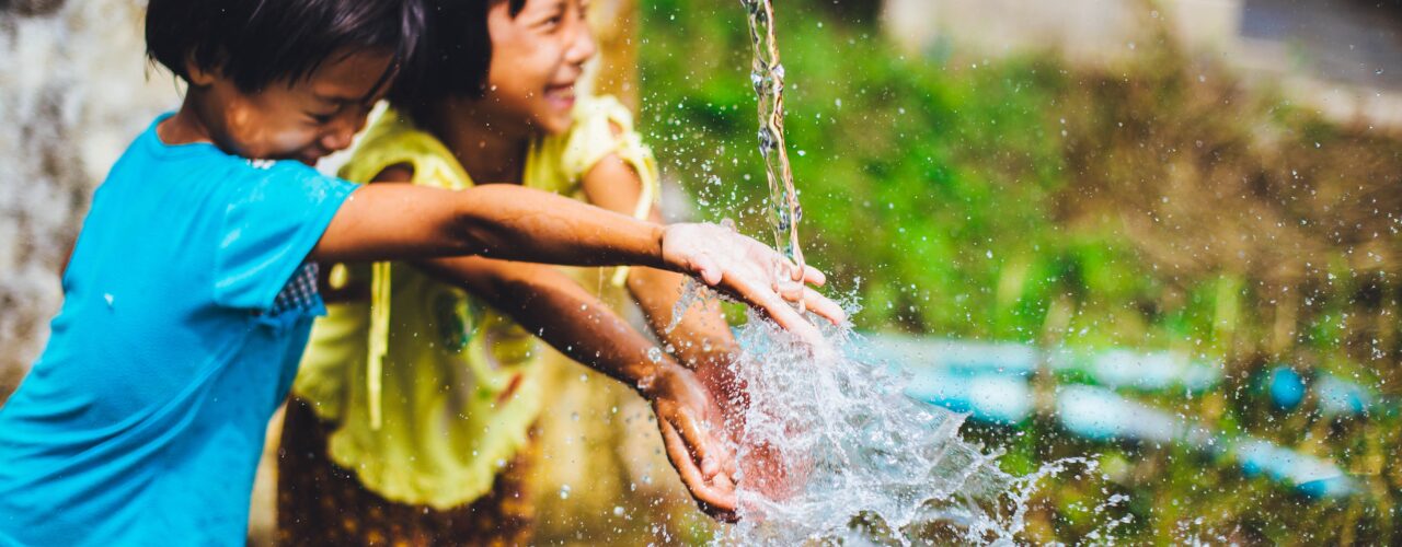 two girl playing water