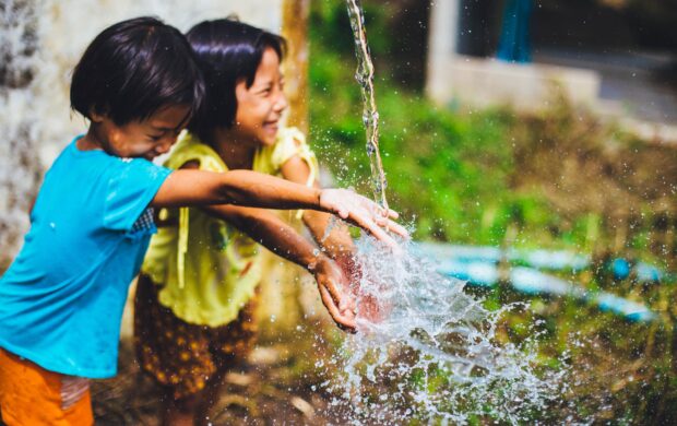 two girl playing water