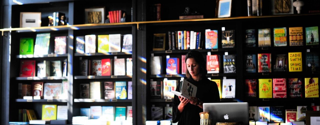 woman standing in front of book shelf