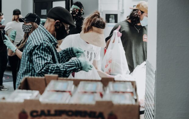 people standing in front of brown cardboard boxes