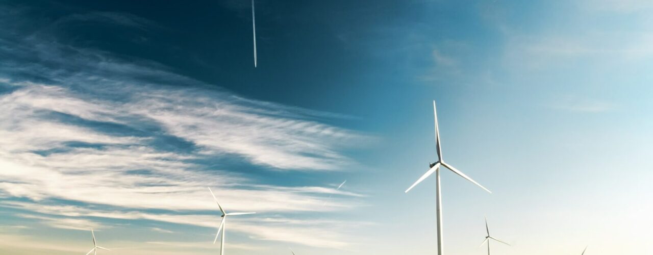 photo of wind turbines on green grass