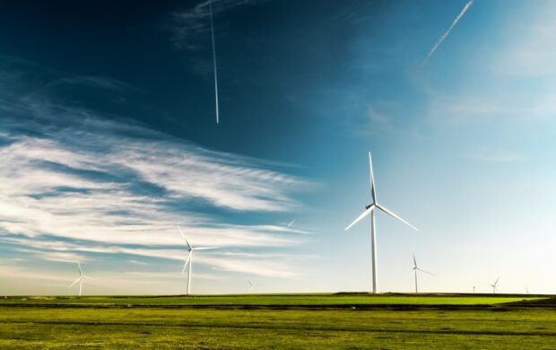 photo of wind turbines on green grass