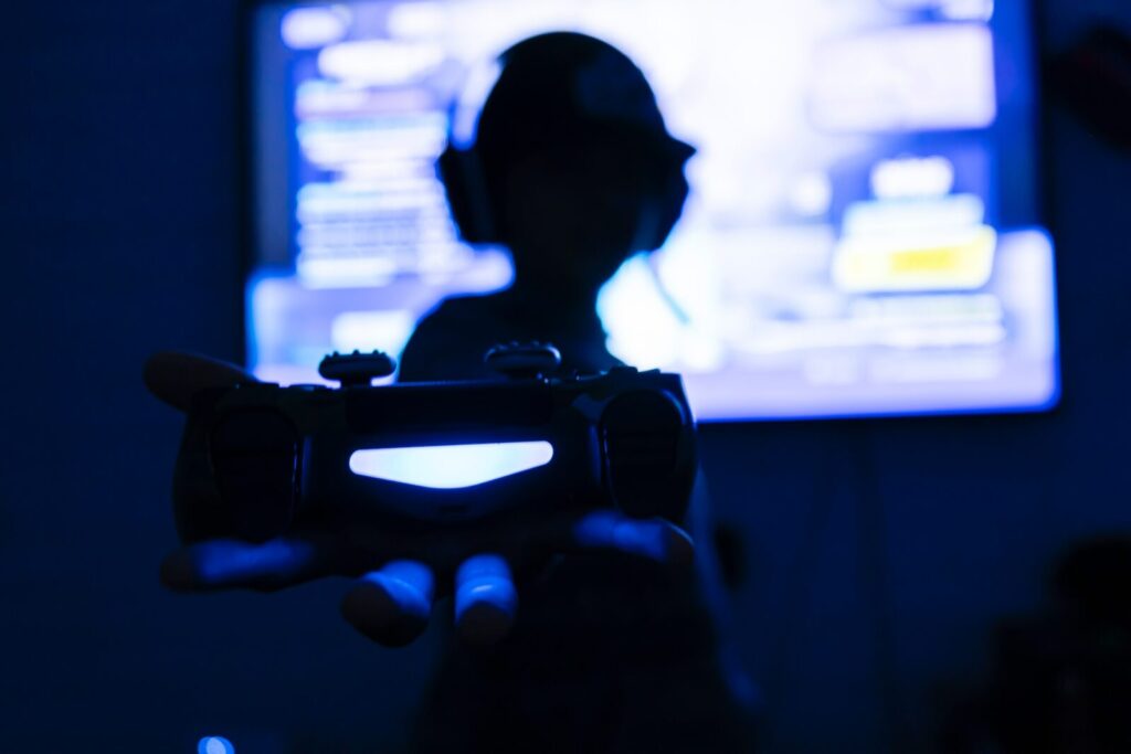 silhouette of teenager in front of screen