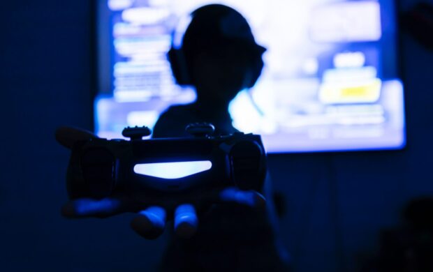 silhouette of teenager in front of screen