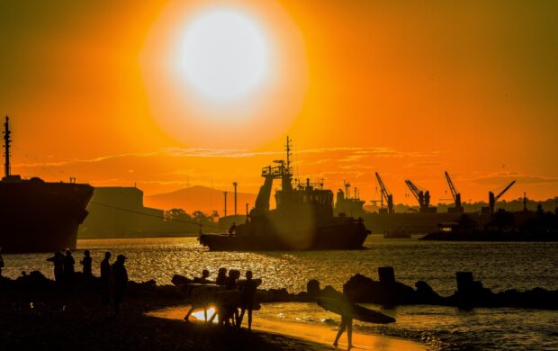 silhouette of people on beach during sunset