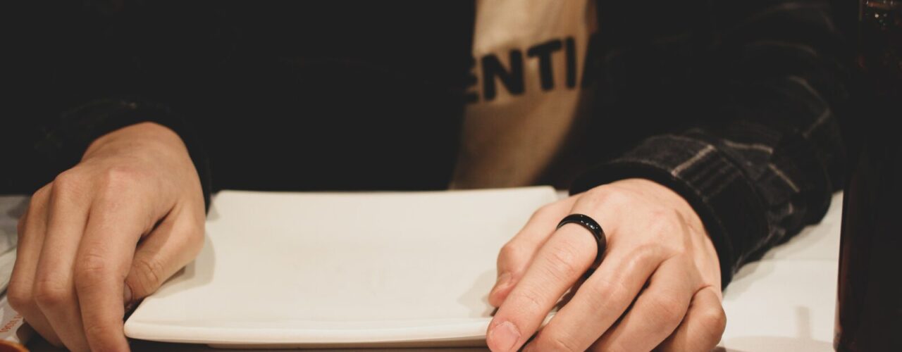 person wearing a black ring