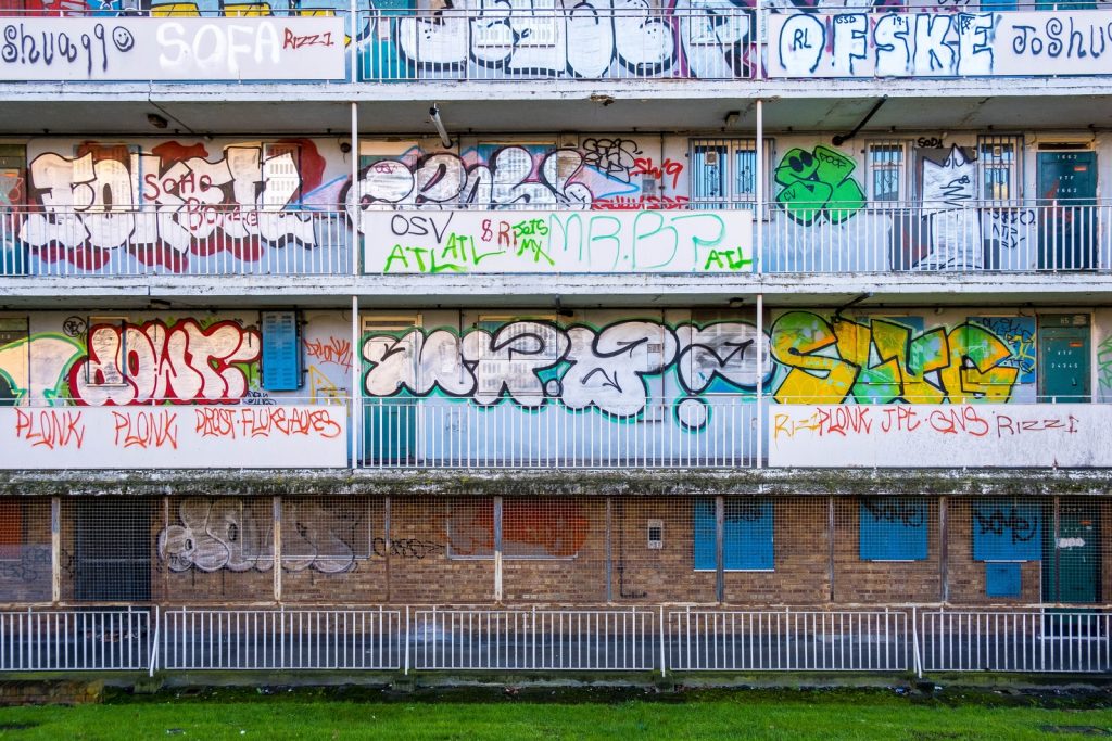 white and blue graffiti on wall