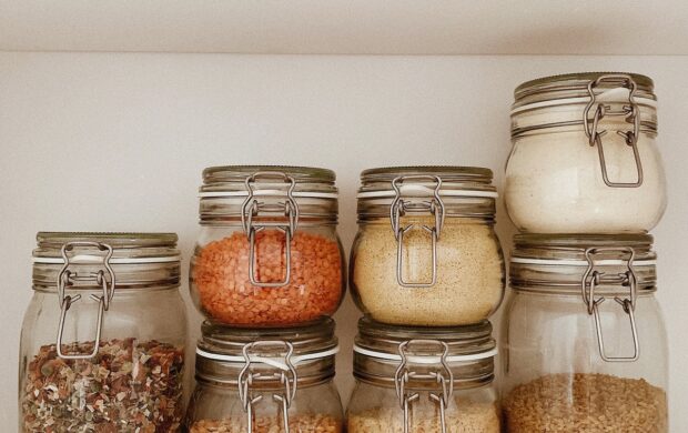 three clear glass jars with brown and white stones