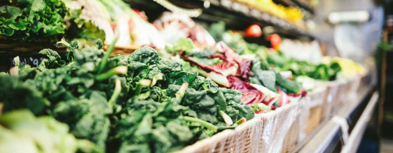 row of vegetables placed on multilayered display fridge