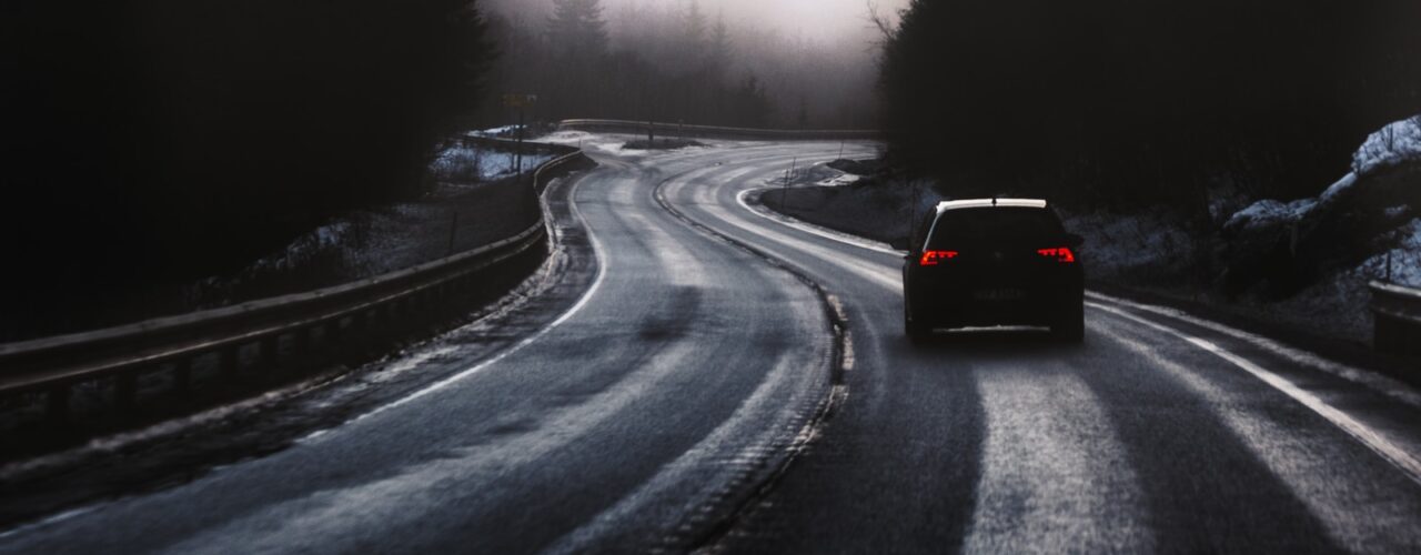 black car on road during foggy weather
