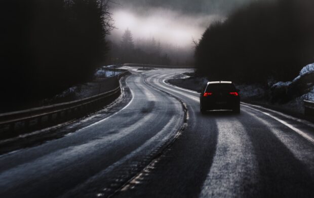 black car on road during foggy weather