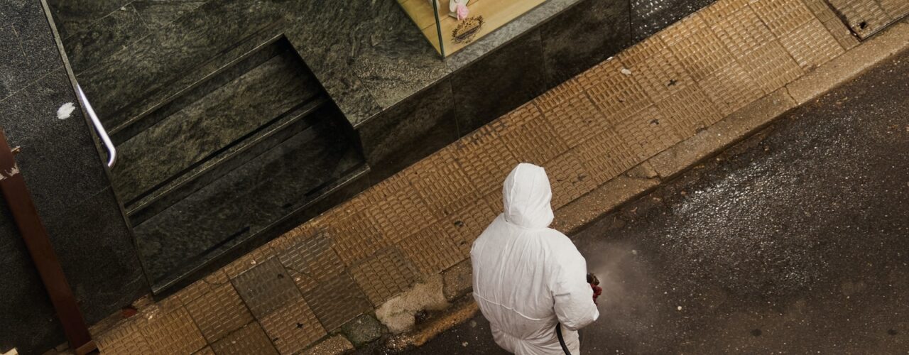 man in white thobe walking on sidewalk during daytime