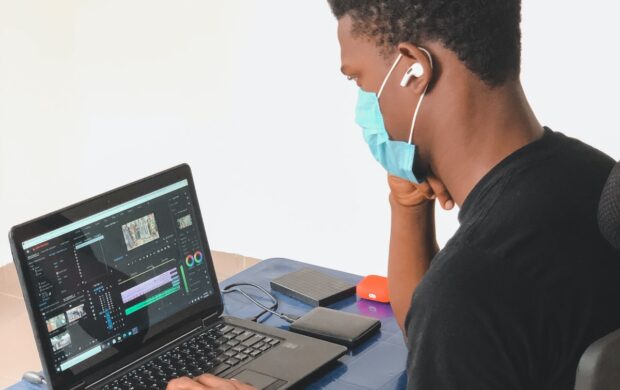 man in black crew neck t-shirt using black laptop computer