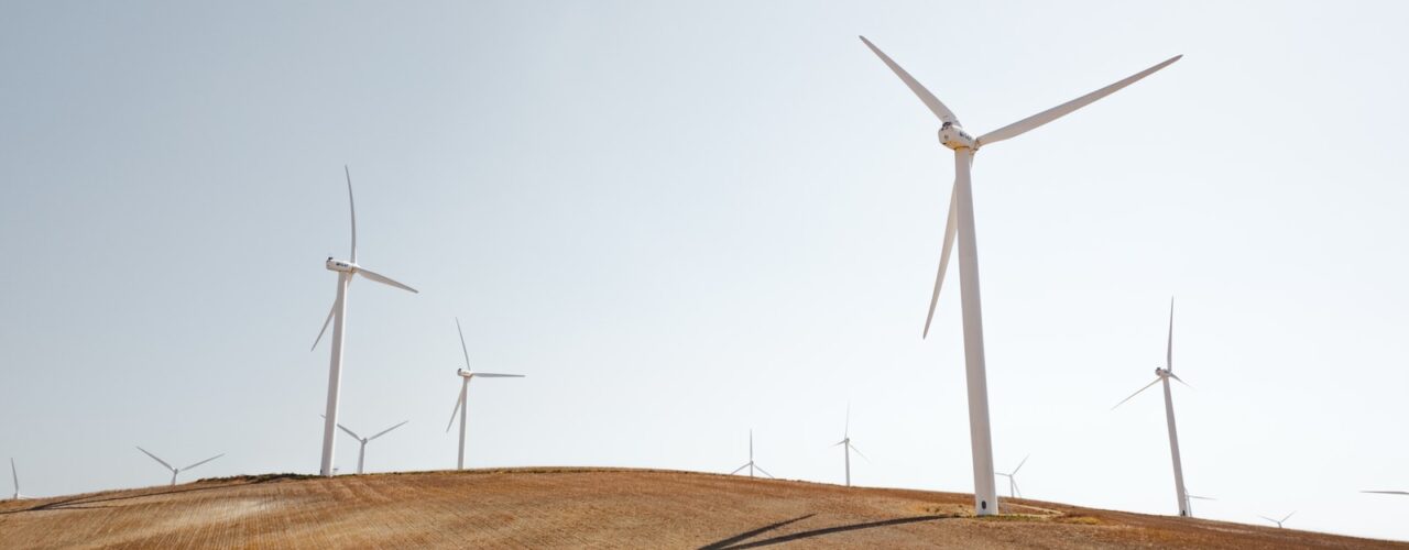 white electric windmills during daytime