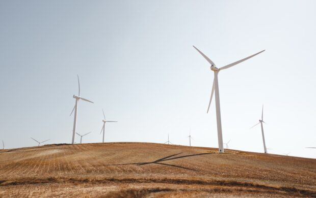 white electric windmills during daytime