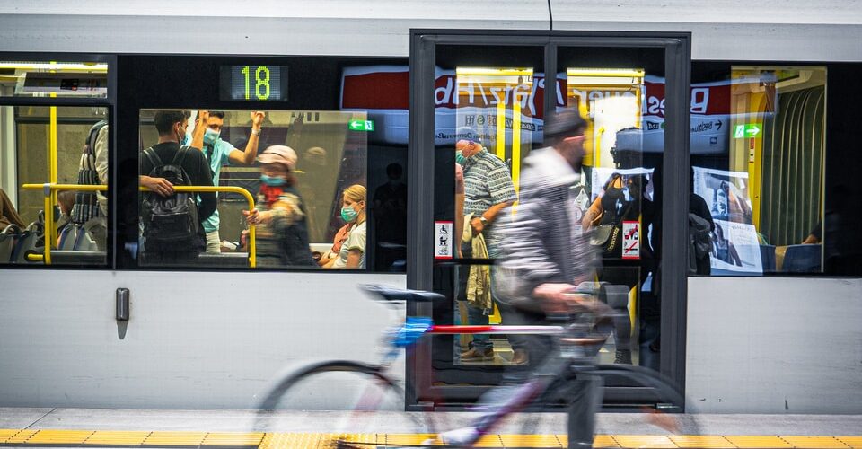 man in black jacket riding bicycle on road during daytime