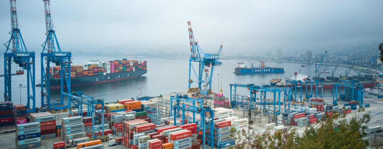 blue and red cargo ship on sea during daytime