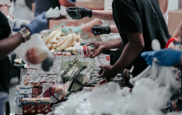 man in black t-shirt holding coca cola bottle