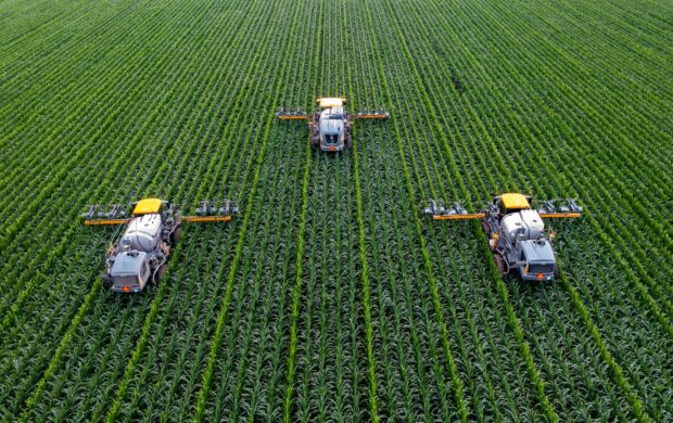 yellow and black heavy equipment on green field during daytime