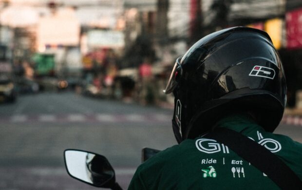 man in green and black jacket wearing black helmet