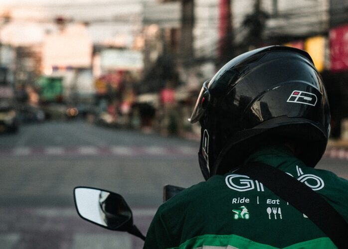 man in green and black jacket wearing black helmet