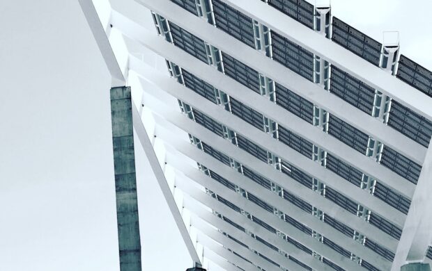 person under white and gray concrete structure during daytime photography