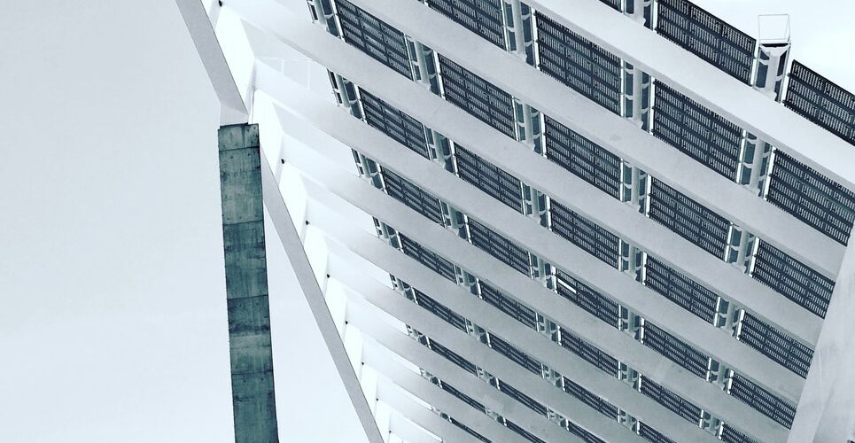 person under white and gray concrete structure during daytime photography