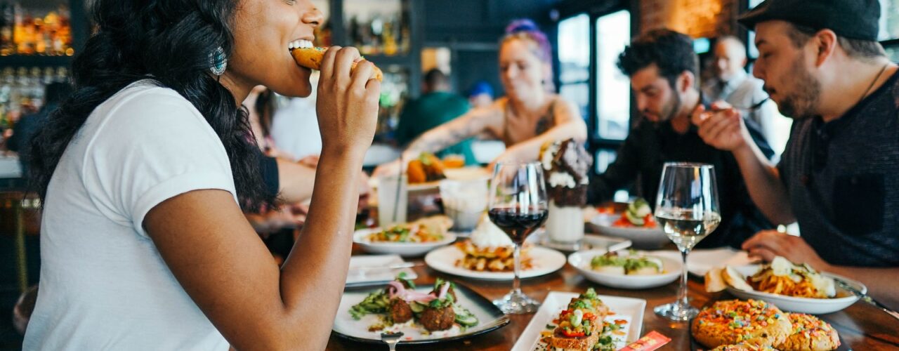 woman in white shirt eating