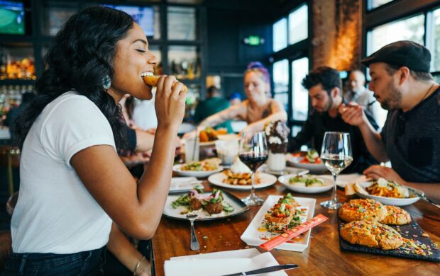 woman in white shirt eating