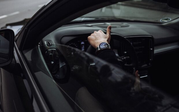 person in black jacket driving car