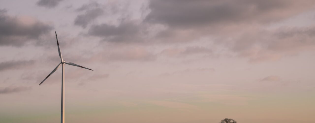 windmill under cloudy sky during daytime