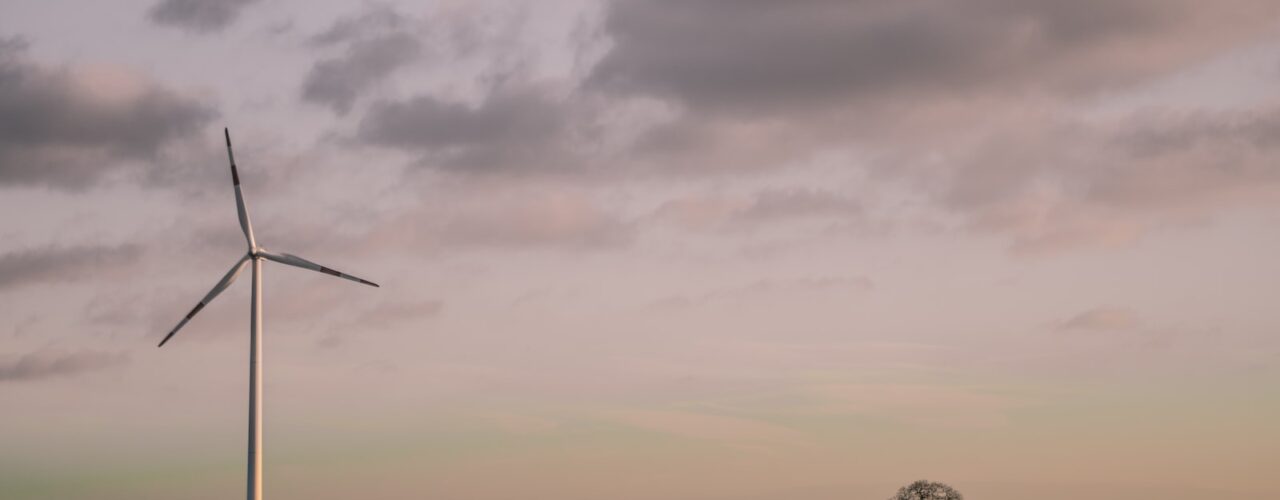 windmill under cloudy sky during daytime