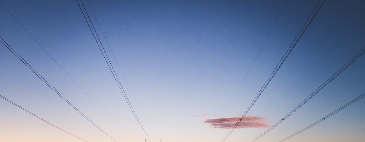 two transmission towers during golden hour