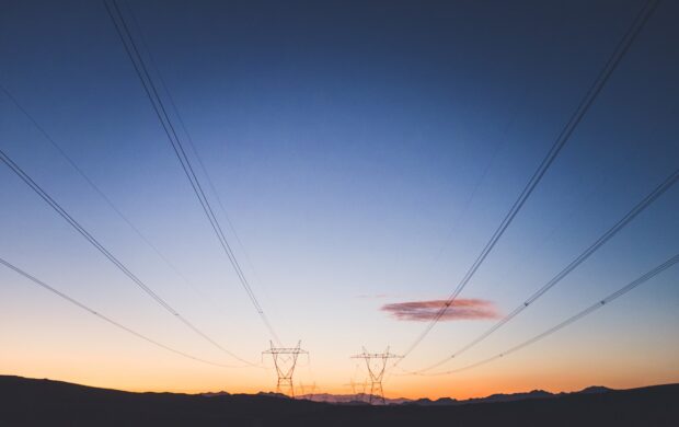 two transmission towers during golden hour