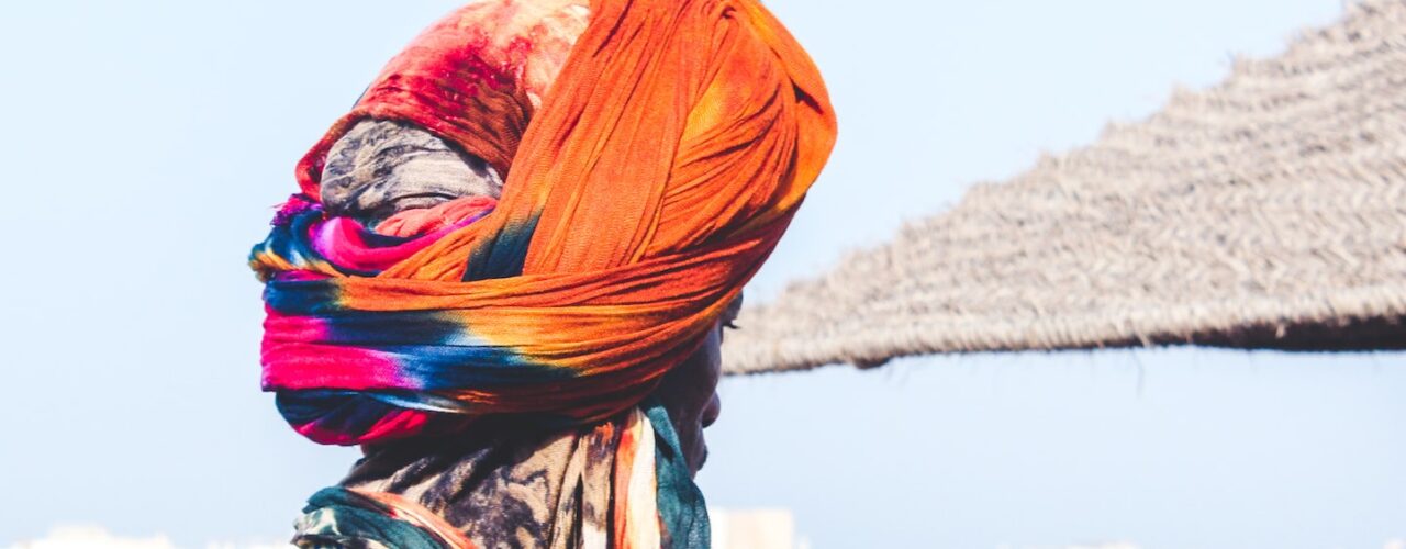 man wearing orange and pink turban