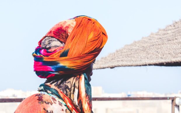 man wearing orange and pink turban