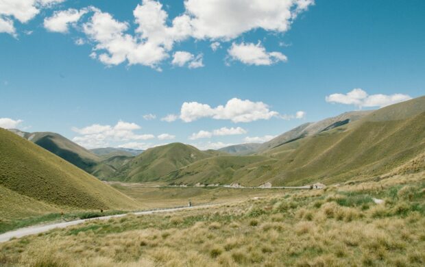 green mountain under white clouds and blue sky during daytime