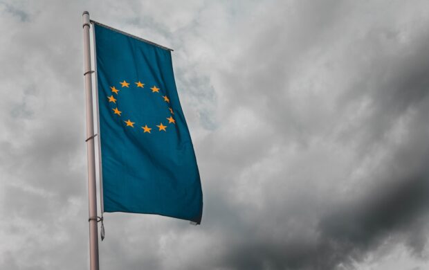 teal flag under cloudy sky