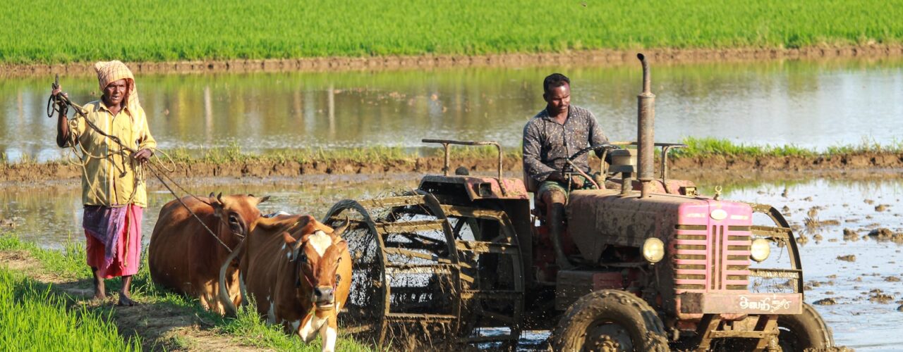 man riding farm equipment during daytime