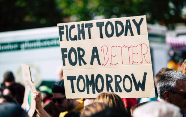 person holding fight today for a better tomorrow sign